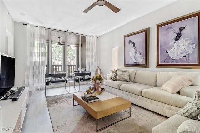 living room featuring wood finished floors and ceiling fan
