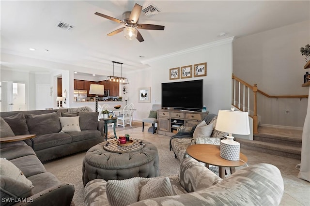 living room featuring crown molding, light tile patterned flooring, ceiling fan, and stairs