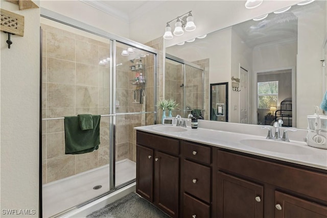 ensuite bathroom with a sink, crown molding, ensuite bathroom, and a stall shower
