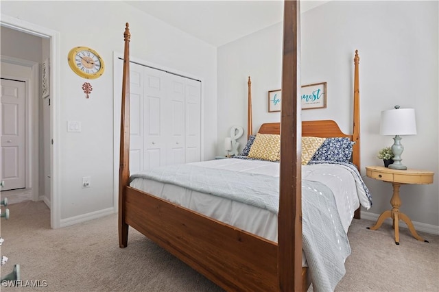 bedroom with baseboards, a closet, and carpet
