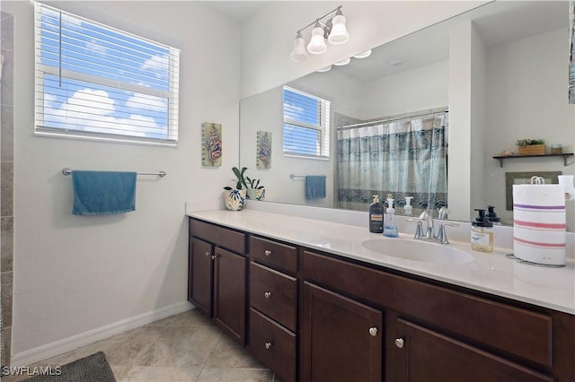 full bath with baseboards, tile patterned flooring, vanity, and curtained shower