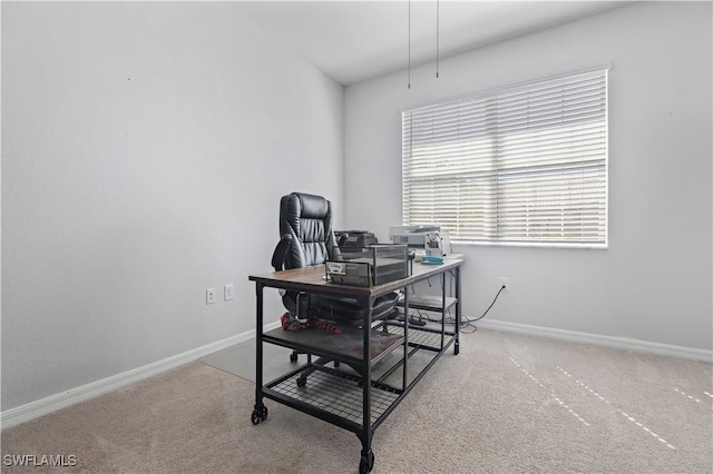carpeted office space with baseboards
