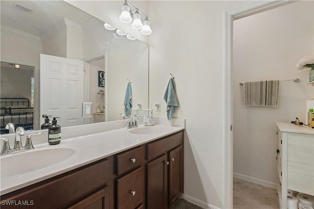 bathroom featuring a sink, double vanity, ornamental molding, and visible vents