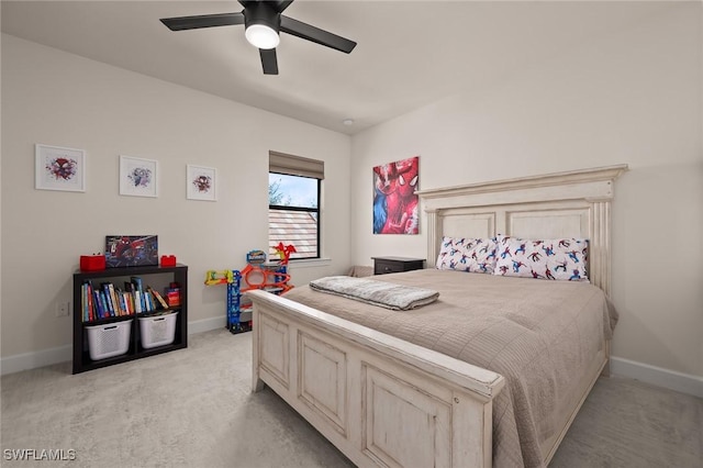 bedroom with light colored carpet, baseboards, and ceiling fan