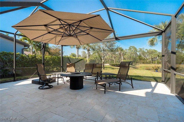 view of patio / terrace featuring a lanai and a fire pit
