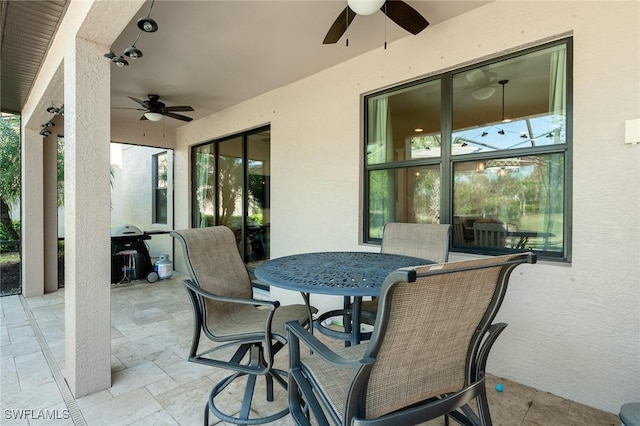 view of patio featuring outdoor dining area and a ceiling fan