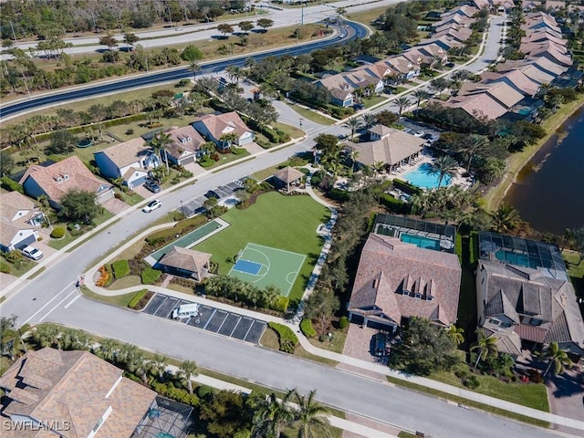 drone / aerial view with a residential view and a water view