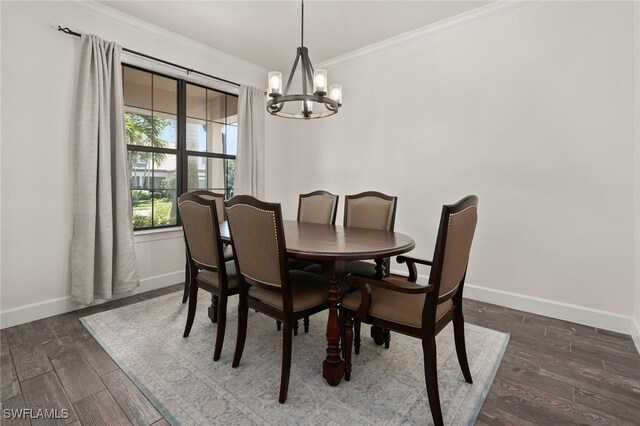 dining room featuring baseboards, dark wood-type flooring, an inviting chandelier, and crown molding