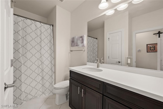bathroom featuring tile patterned floors, toilet, and vanity