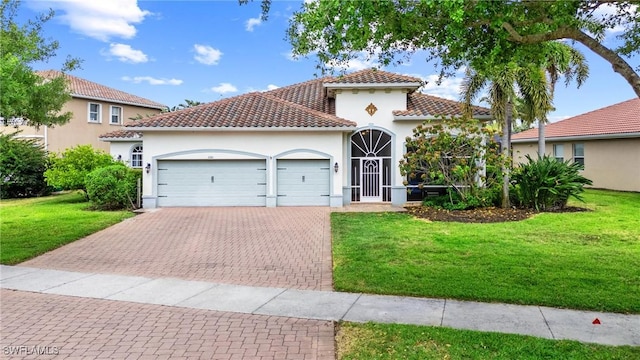 2160 Vardin Pl, Naples, FL 34120 - mediterranean / spanish home with an attached garage, a tile roof, stucco siding, a front lawn, and decorative driveway