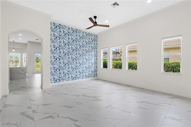 2160 Vardin Pl, Naples, FL 34120 - spare room with marble finish floors, baseboards, arched walkways, a ceiling fan, and wallpapered walls