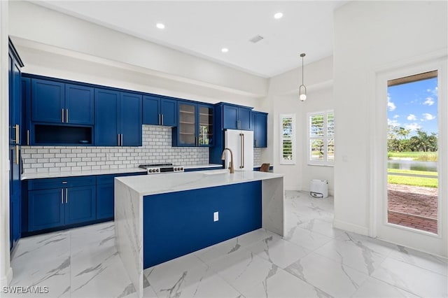 2160 Vardin Pl, Naples, FL 34120 - kitchen featuring a sink, stove, a center island with sink, high end refrigerator, and blue cabinetry