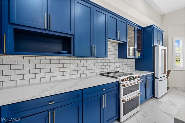 2160 Vardin Pl, Naples, FL 34120 - kitchen with double oven range, blue cabinets, freestanding refrigerator, light marble finish floors, and tasteful backsplash