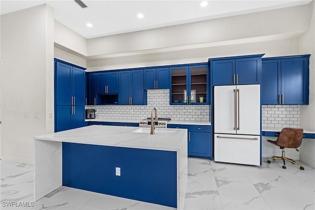 2160 Vardin Pl, Naples, FL 34120 - kitchen featuring freestanding refrigerator, light marble finish flooring, blue cabinets, glass insert cabinets, and backsplash