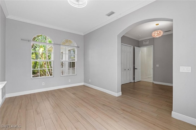 2160 Vardin Pl, Naples, FL 34120 - unfurnished room featuring arched walkways, light wood-type flooring, baseboards, and ornamental molding