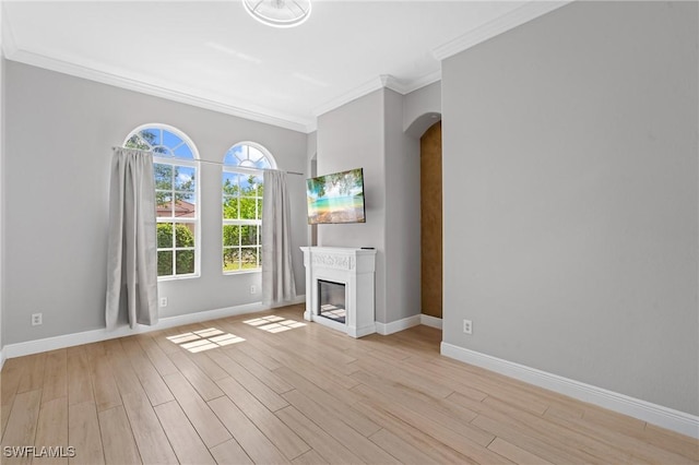 2160 Vardin Pl, Naples, FL 34120 - unfurnished living room with crown molding, arched walkways, light wood finished floors, and baseboards