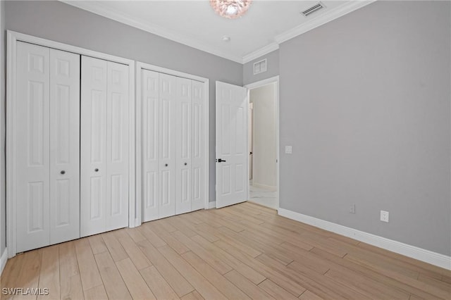 2160 Vardin Pl, Naples, FL 34120 - unfurnished bedroom with multiple closets, baseboards, light wood finished floors, and ornamental molding