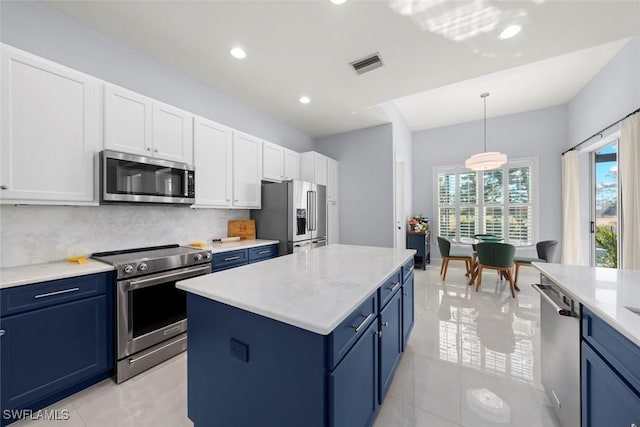 9119 Links Dr, Fort Myers, FL 33913 - kitchen featuring blue cabinetry, white cabinetry, stainless steel appliances, backsplash, and visible vents
