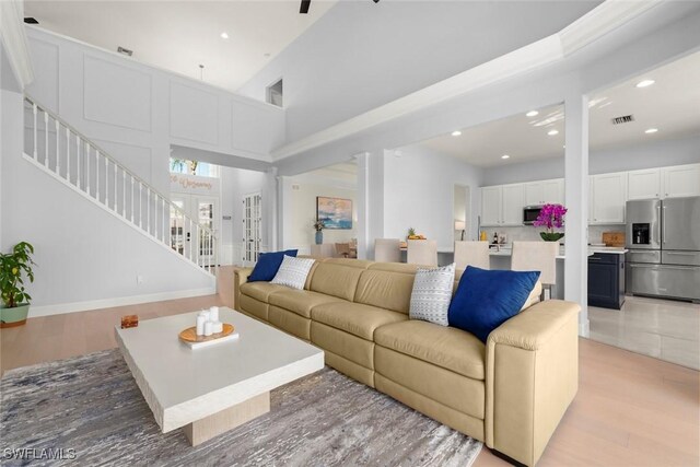 9119 Links Dr, Fort Myers, FL 33913 - living area featuring visible vents, stairs, recessed lighting, light wood-type flooring, and a high ceiling