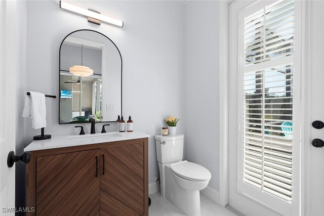 9119 Links Dr, Fort Myers, FL 33913 - bathroom with toilet, tile patterned flooring, and vanity
