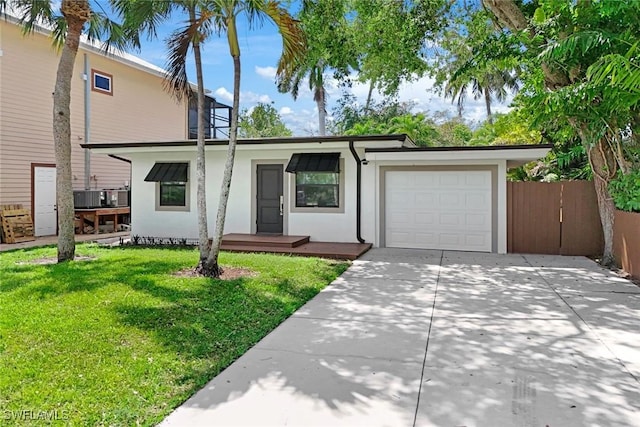 view of front of home with a garage, stucco siding, concrete driveway, and a front lawn