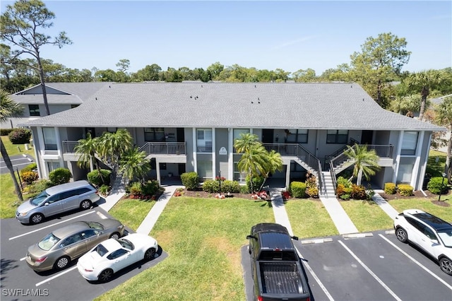 1232 Commonwealth Cir Unit P103, Naples, FL 34116 - view of property featuring stairway and uncovered parking