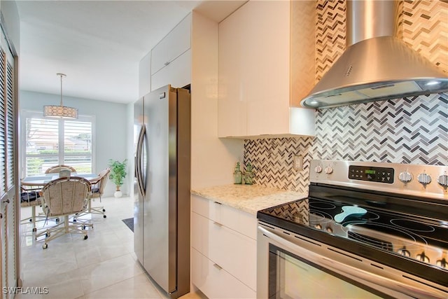 1232 Commonwealth Cir Unit P103, Naples, FL 34116 - kitchen with light tile patterned floors, light stone countertops, appliances with stainless steel finishes, wall chimney range hood, and backsplash
