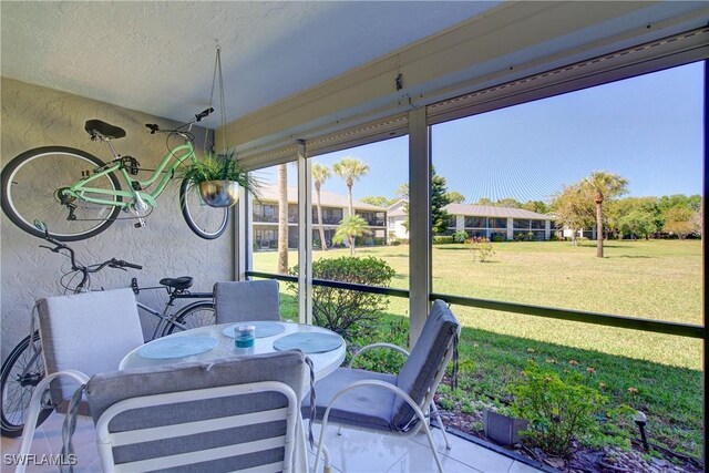 1232 Commonwealth Cir Unit P103, Naples, FL 34116 - sunroom / solarium with outdoor dining area