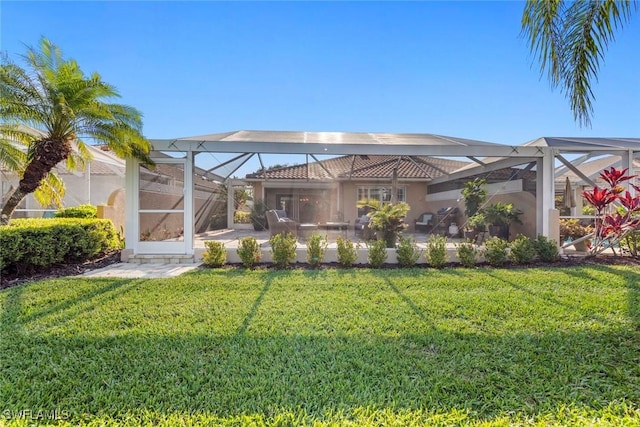 28970 Vermillion Ln, Bonita Springs, FL 34135 - back of property featuring a patio, glass enclosure, a lawn, and stucco siding