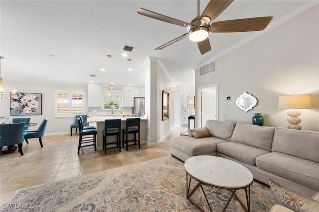 28970 Vermillion Ln, Bonita Springs, FL 34135 - living area with crown molding, a chandelier, ceiling fan, light tile patterned floors, and baseboards