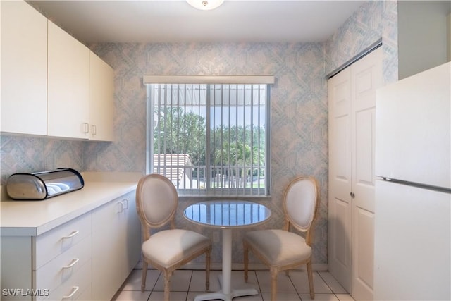 dining room with light tile patterned floors and wallpapered walls