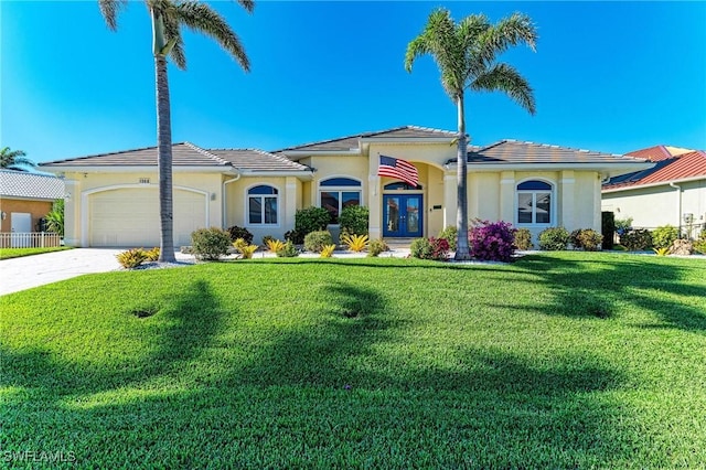 1368 Grebe Dr, Punta Gorda, FL 33950 - mediterranean / spanish-style home with a front lawn, french doors, driveway, and stucco siding