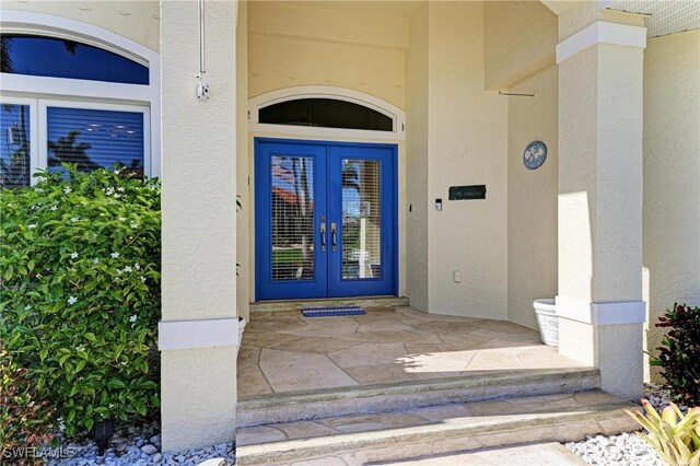 1368 Grebe Dr, Punta Gorda, FL 33950 - entrance to property with french doors and stucco siding