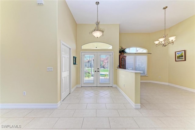 1368 Grebe Dr, Punta Gorda, FL 33950 - entryway featuring light tile patterned flooring, french doors, baseboards, and a chandelier