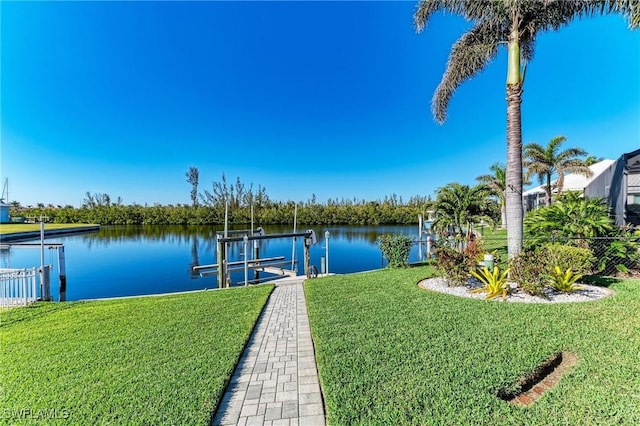 1368 Grebe Dr, Punta Gorda, FL 33950 - view of dock featuring boat lift, a water view, and a lawn