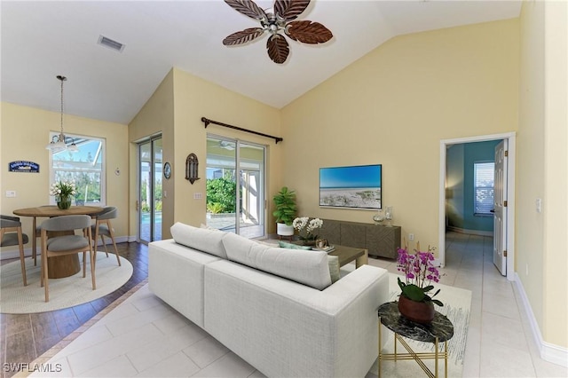 1368 Grebe Dr, Punta Gorda, FL 33950 - living room with a wealth of natural light, visible vents, high vaulted ceiling, and a ceiling fan