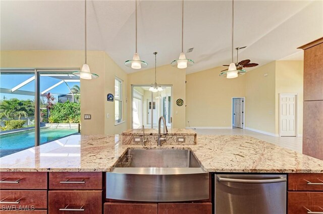 1368 Grebe Dr, Punta Gorda, FL 33950 - kitchen with light stone counters, a sink, stainless steel dishwasher, decorative light fixtures, and open floor plan