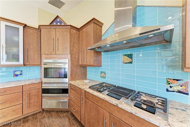 1368 Grebe Dr, Punta Gorda, FL 33950 - kitchen featuring visible vents, wood tiled floor, stainless steel appliances, a warming drawer, and wall chimney exhaust hood
