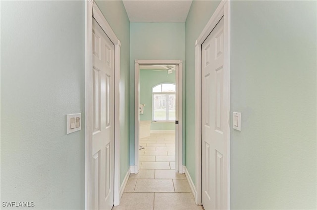 1368 Grebe Dr, Punta Gorda, FL 33950 - hallway with light tile patterned floors and baseboards