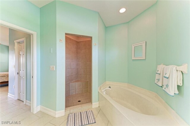1368 Grebe Dr, Punta Gorda, FL 33950 - ensuite bathroom featuring baseboards, tile patterned flooring, a shower stall, ensuite bathroom, and a bath