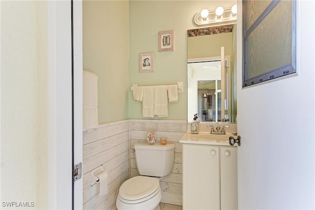 1368 Grebe Dr, Punta Gorda, FL 33950 - bathroom with a wainscoted wall, toilet, and vanity