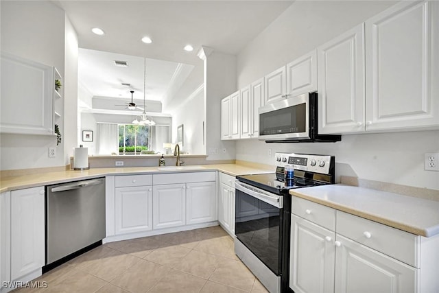 8120 Sanctuary Dr Unit 1, Naples, FL 34104 - kitchen featuring stainless steel appliances, a sink, white cabinets, and recessed lighting