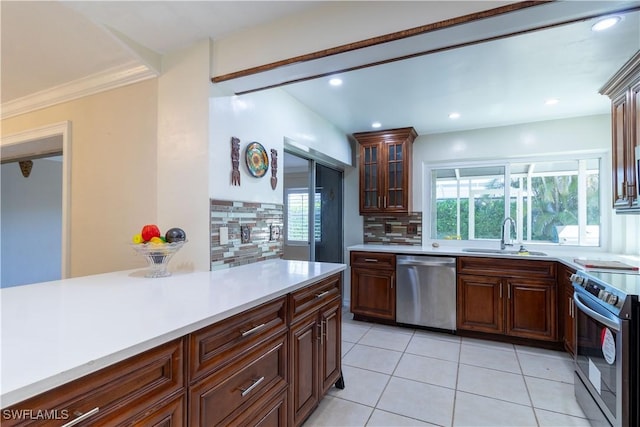 209 Pinehurst Cir, Naples, FL 34113 - kitchen featuring a sink, a wealth of natural light, light countertops, and appliances with stainless steel finishes