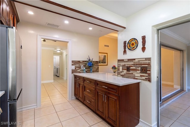 209 Pinehurst Cir, Naples, FL 34113 - kitchen with visible vents, light countertops, light tile patterned floors, and freestanding refrigerator