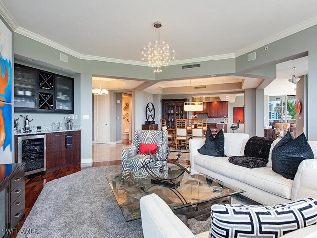 5051 Pelican Colony Blvd Unit 301, Bonita Springs, FL 34134 - living room with wine cooler, a chandelier, visible vents, indoor wet bar, and wood finished floors