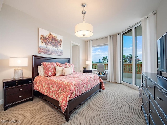 5051 Pelican Colony Blvd Unit 301, Bonita Springs, FL 34134 - bedroom featuring light carpet, access to outside, and a wall of windows