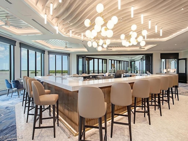 5051 Pelican Colony Blvd Unit 301, Bonita Springs, FL 34134 - bar featuring crown molding, decorative light fixtures, and an inviting chandelier