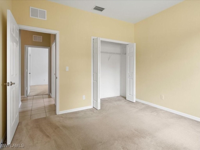 unfurnished bedroom with carpet flooring, visible vents, and baseboards