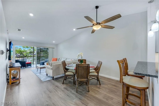 dining area featuring a ceiling fan, visible vents, wood finished floors, lofted ceiling, and recessed lighting