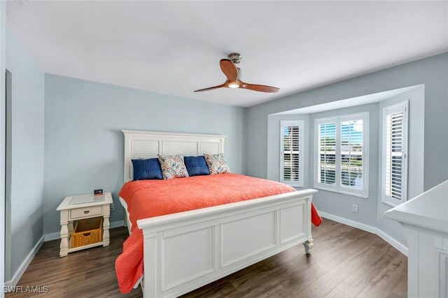 bedroom featuring dark wood-type flooring, a ceiling fan, and baseboards
